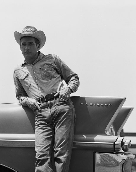 In character as rancher Hud Bannon, Newman leans against the tail fin of a pink 1958 Cadillac during the filming of Martin Ritt’s 1963 classic, Hud. By Bradley Smith/Corbis.